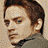A pixelated image of a person with brown hair in three distinct poses showing different angles and expressions against varied backgrounds.