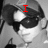 A black-and-white image of a person wearing sunglasses and a cap, with red text overlays changing across four