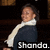 Pixelated image of a person in dark clothing with white collar, standing against dark background and text reading 'Shando.' at bottom.