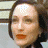 A 48x48 pixel buddy icon split into two frames showing a woman's face on the left and green text on a dark background on the right, with visible pixelation and dithering effects.