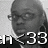 Pixelated grayscale image of a person's face with visible glasses and partial text reading 'RI 33' in blocky white font on dark background.
