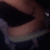 A static image of a person's lower body wearing dark shorts and a light-colored belt, with a white object on the right side.