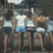 Four pixelated figures in white tops and dark bottoms stand side-by-side against a muted background with light blue accents.