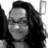 Black-and-white pixelated image of a person with long dark hair, closed eyes, and a neutral expression against a plain background.