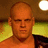 Pixelated image of a bald man with serious expression, red text "KANE" and "THE BIG RED MACHINE" on black background.