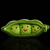 Green pea pod with three smiling faces, each with black eyes and red mouths, set against a black background with a reflection below.
