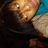 A pixelated close-up of a person with light brown skin, dark hair, and a blue top, showing subtle facial expression changes across frames.