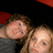 Two pixelated faces with light skin tones and brown hair appear in close proximity against a dark background with red accents.