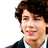 Pixelated image of a person with curly brown hair wearing dark clothing over a white shirt, set against a bright yellow background with blue text.