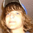 A person with brown hair and a blue-accented cap appears in four -aligned , each showing subtle variations in facial lighting and expression