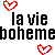 Pixelated text repeats 'la vie' and 'bohemeb' with red heart symbols on a white background, showing color variations in the letters.