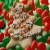 Pixelated static image of a figure in light-colored clothing holding an object against red and green background with scattered white dots.