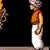 Pixelated character in orange tunic and white pants stands in profile against black background with brown ground line.