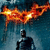 A dark figure stands beneath a fiery bat symbol against a blue background, with the bat's glow shifting between frames.