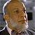 Static pixelated image of a person's head and shoulders with light brown hair, visible ear, and partial neck against a gray background.