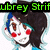 Pixelated cartoon character with dark hair, blue highlights, red cheeks, and brown eyes in a static pose.