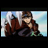 Pixelated anime-style character with long brown hair and white streaks, wearing red jacket and dark pants, leaning forward against blue sky background with white clouds.