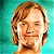 A pixelated contact sheet showing two frames of an animated icon featuring a cartoon character with light brown hair against a teal background and green text reading "Original Icons .com" on the right side.