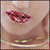 A close-up of a person's mouth with red lipstick, showing three of lips moving from a closed position to a slightly open position