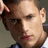 A pixelated close-up of a person's face with a hand near the head, transitioning to a version with cyan text overlay.