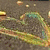 Animated icon with green and yellow streaks forming a heart shape against a brown background, transitioning to a metallic heart outline on silver.