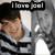 A pixelated image shows a person in a light blue shirt with dark stripes, holding a white object near their face under the text 'I love you!' on a black banner.