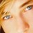 Pixelated close-up of a person's face showing eyes, eyebrows, and part of the nose with warm-toned skin tones.