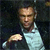 Pixelated image of a person in a light-colored shirt against a dark background, with one arm extended forward.