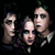 Three pixelated human faces in profile view against a dark background, with visible facial features and clothing details.