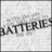 Pixelated grayscale image showing partial text reading 'BATTERIES' on a light background with dark border.