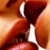 A close-up of lips and teeth in two color variations, one warm-toned orange-red and the other grayscale.