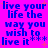 Pixelated blue text on bright pink background with orange starbursts, repeating 'live your life the way you wish to live it' in four identical sections.