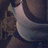 A pixelated image of a person's lower legs and feet in dark shoes, with blue text overlays reading "s3xY" at top right and "ShOrTy" at bottom left.