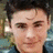 Pixelated portrait of a person with dark hair and a blue garment, next to a black background with white pixelated text reading 'zachary david alexander efron 33'.
