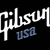 Pixelated white and blue text on black background reads 'Gibson USA' with stylized lettering.
