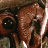 A 48x48 pixel buddy icon split into two frames showing a close-up of a brown insectoid creature's face on the left and green text reading "Original Icons .com" on a dark green background on the right.