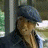 A 48x48 pixel animated buddy icon featuring a person in a cap and denim jacket on the left frame, transitioning to bold blue text reading "honey" on the right frame against a dark background.