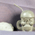 A pixelated image shows a light-colored dome-shaped object with a dark shadowed section and a thin vertical line extending from its top against a muted purple background.