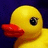 Yellow rubber duck with red beak against dark blue background, next to yellow with pixelated text "I got plastic surgery"