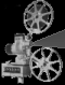 Black-and-white animated icon showing a film projector with two reels, one above and one below the main body; text "GIFCITIES" visible on base.