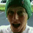 A pixelated image shows a person with green hair and open mouth on the left, next to text reading "a day without MIKE" above and "is like a day without sunshine." on black background.