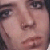 Static close-up of a person's face with light skin tone, visible eyes, nose, and mouth, rendered in low-resolution pixelation.