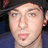 A static image shows a person wearing a dark cap and blue clothing with red text reading '3 Letters H' above two symbols: an O on the left and T!! on the right.