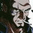 Pixelated static image of a character's face with visible facial features and dark background elements, likely from an anime-style buddy icon set.