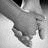 Black-and-white animated sequence showing two hands clasping, with text overlays changing across frames to form the phrase "put your hand in mine... I'll never let go.".