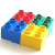 Pixelated 3D block structure with blue, yellow, red, and green sections on a white background.