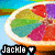 Pixelated image of a colorful fruit slice on a plate with text 'Jackie' and a heart symbol below it.