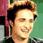 A static image of a person with light brown hair and a black jacket against a green background.