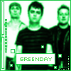 Green-tinted image of three people in dark striped shirts with 'GREENDAY' text below, framed by vertical green borders and square pixel elements.