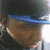 Pixelated close-up of a figure wearing dark clothing and a blue headband, with brown hair visible beneath the band.